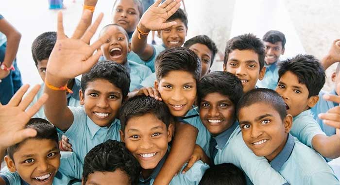 There are many children in this  image  with smiling faces to benefit of Uttar Pradesh Scholarship Yojana.

