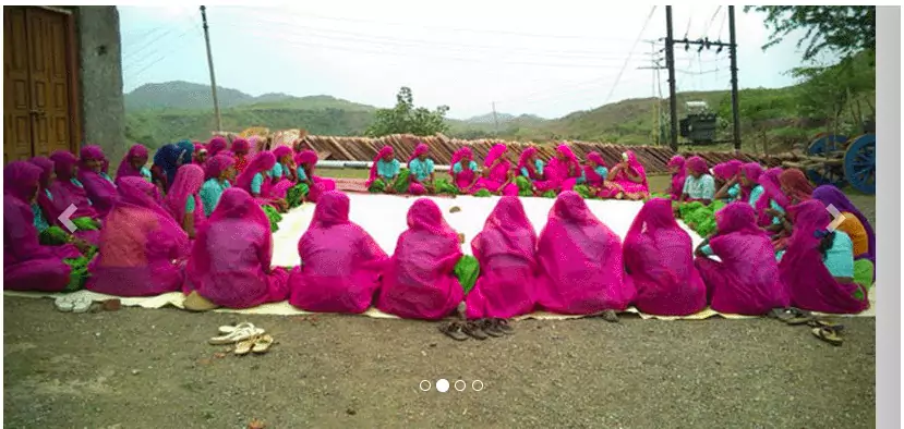 rural women sit together and discuss progress of projects